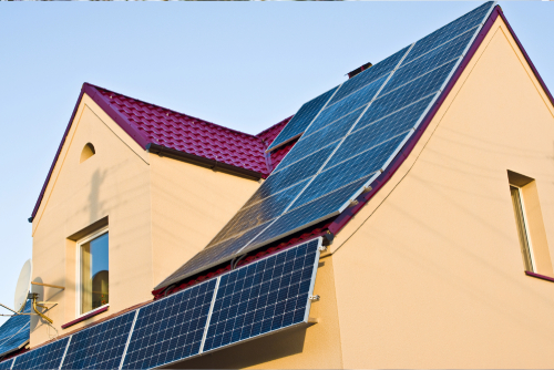 Solar panels are installed on the roofs of modern buildings, to support the renewable and environmentally friendly energy movement.