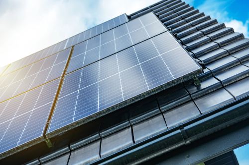 Solar panels mounted on the exterior of a building, highlighting the integration of green technology in architecture.