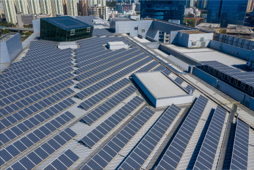 Bird's-eye view of a building rooftop with solar panels, highlighting sustainable energy solutions.