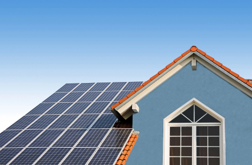 A house with solar panels on its roof, showcasing sustainable and renewable energy solutions.