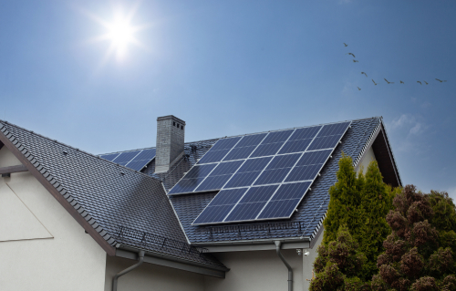 Roof-mounted solar panels on a residential home, promoting eco-friendly energy use.