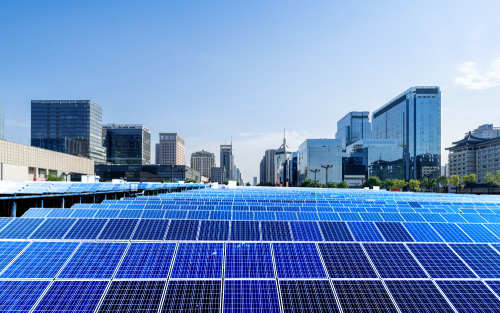 Rooftop solar panels overlooking a cityscape, showcasing renewable energy in an urban environment.